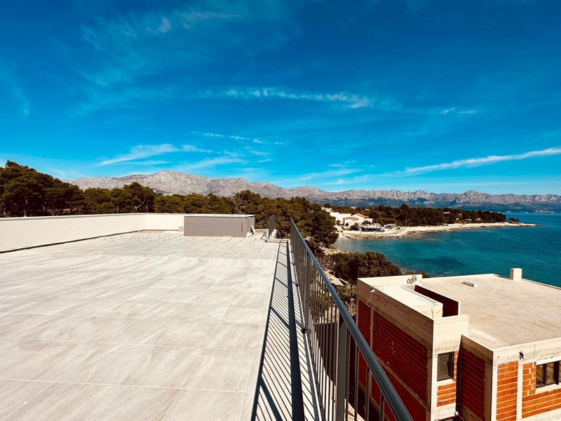 Taras na dachu z widokiem na morze i góry.