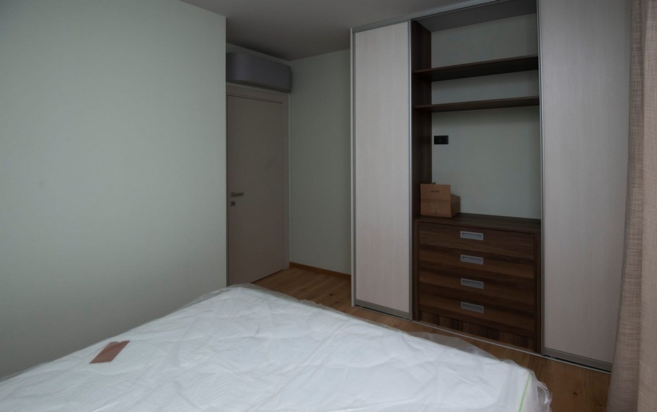 na sprzedaż przestronna sypialnia w nowoczesnym mieszkaniu w Splicie w Chorwacji, z wbudowaną szafą i drewnianą podłogą.