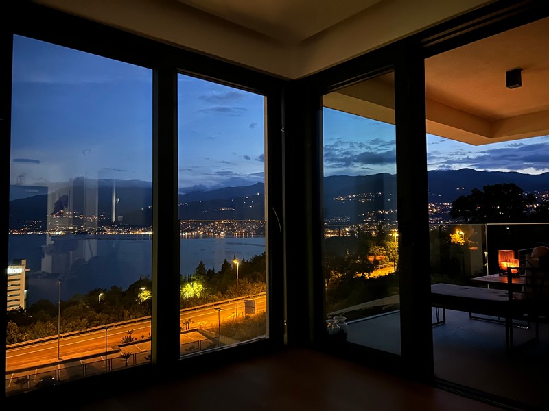 Nocny widok z balkonu mieszkania w Rijece z widokiem na oświetlone wybrzeże.