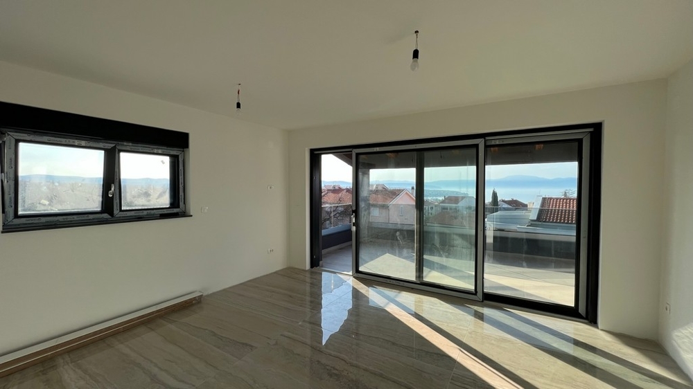 Przestronny salon z dużymi przeszkleniami i wyjściem na taras, marzenie dla nieruchomości w Chorwacji.