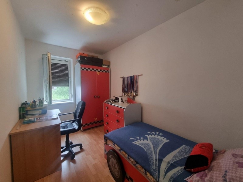 Pokój dziecięcy z biurkiem i czerwoną szafą