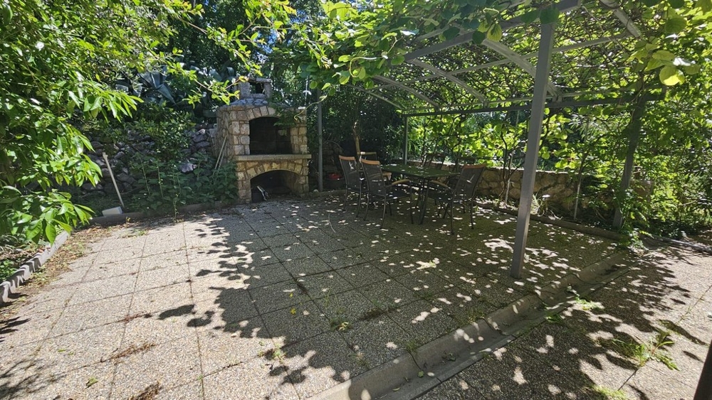 Ogród z zadaszoną częścią wypoczynkową i grillem