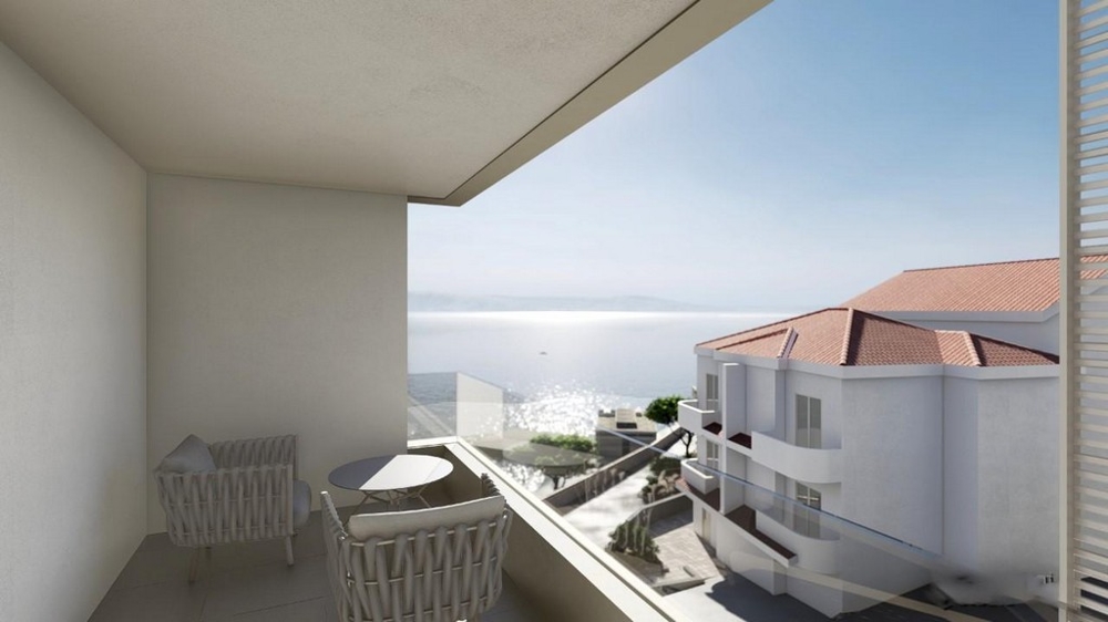 Widok zewnętrzny nowoczesnego budynku mieszkalnego ze znaczkami „Sprzedane” na dwóch piętrach i otaczającymi je terenami zielonymi