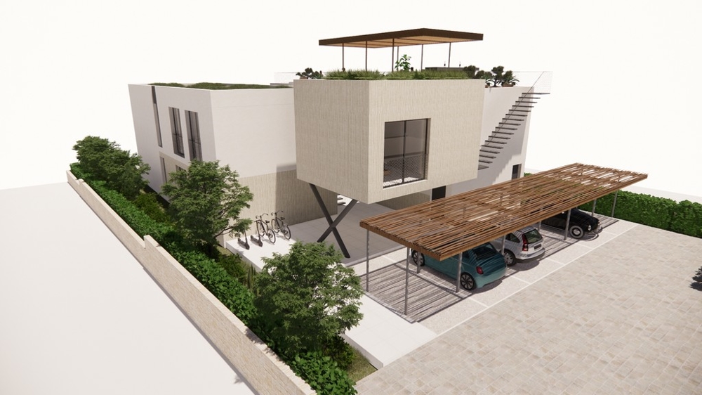 Tył budynku z zadaszonym parkingiem.