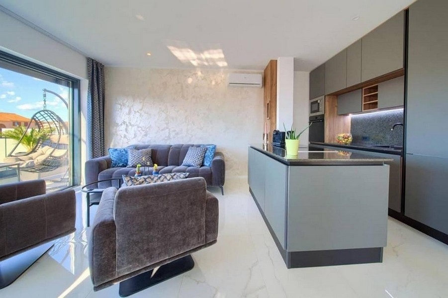 Wysokiej jakości apartament z nowoczesną kuchnią i widokiem na taras.