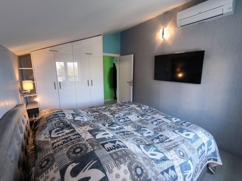 Sypialnia z dużym łóżkiem i telewizorem