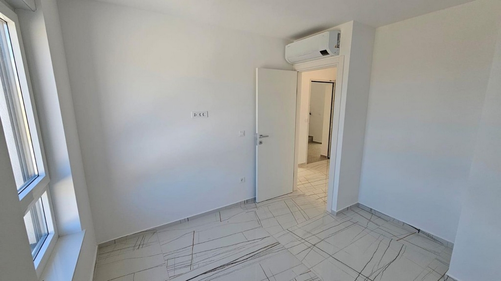 Jasne płytki w klimatyzowanej sypialni.