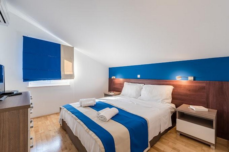 Sypialnia z podwójnym łóżkiem i niebieskimi akcentami