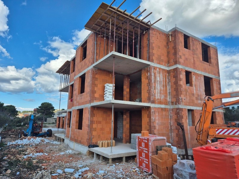 Wygląd zewnętrzny budynku mieszkalnego w budowie z czerwonej cegły