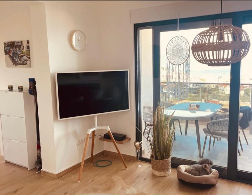 Pokój dzienny z telewizorem i wyjściem na taras