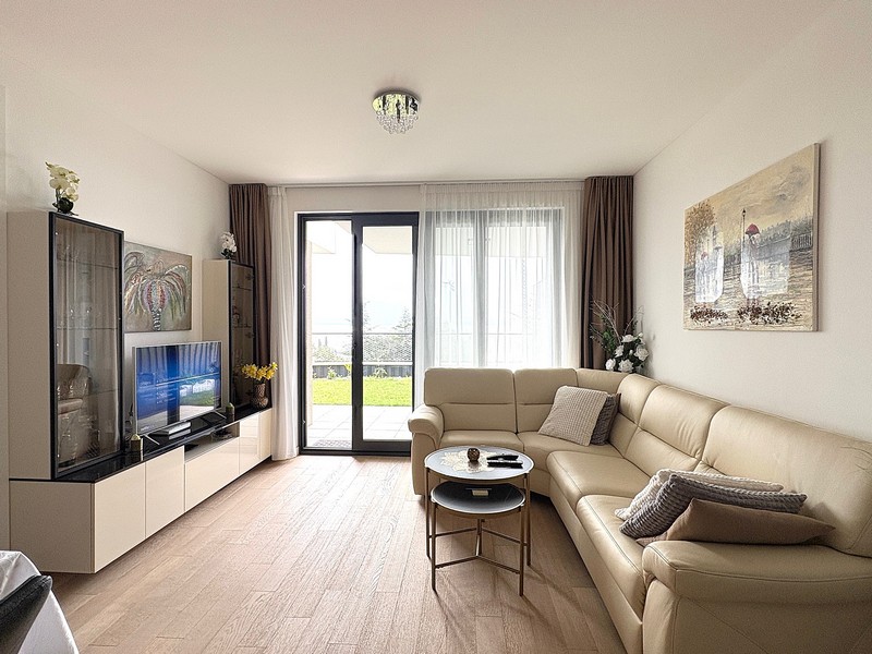 Umeblowany salon z widokiem na ogród.