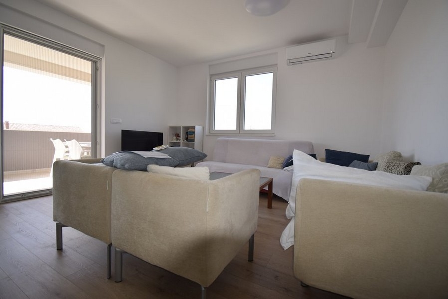 Jasny salon z sofą i wyjściem na taras