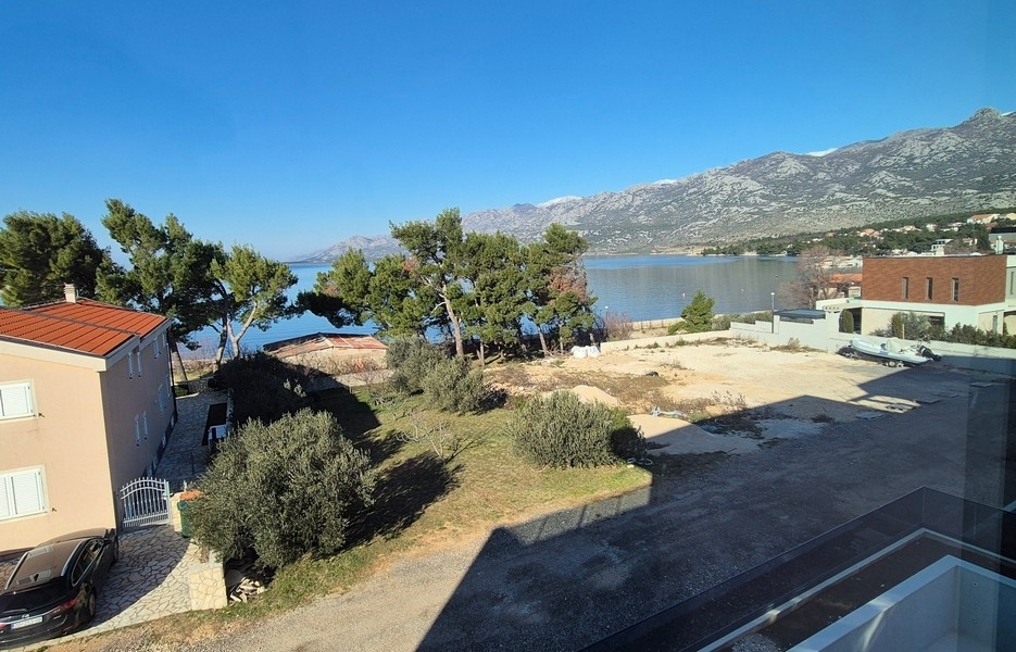 Widok na morze, drzewa i sąsiednie budynki