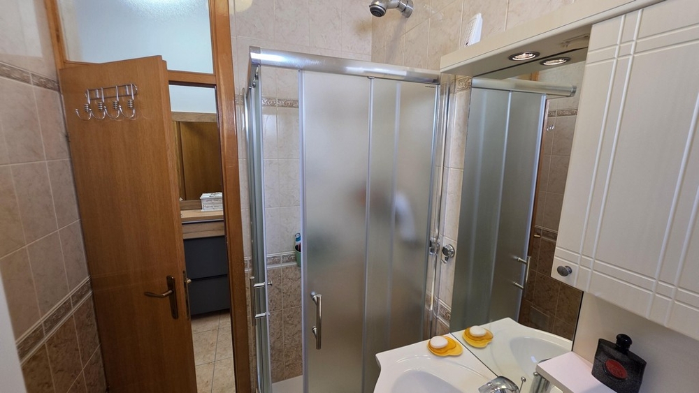 Łazienka z kabiną prysznicową i umywalką