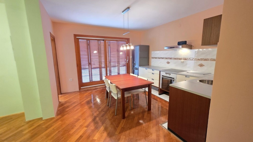 Część dzienna z kuchnią i stołem jadalnym oraz wyjściem na balkon