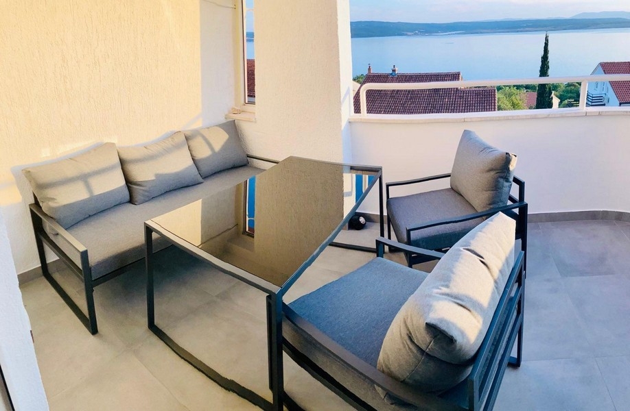 Balkon z meblami wypoczynkowymi i widokiem na morze
