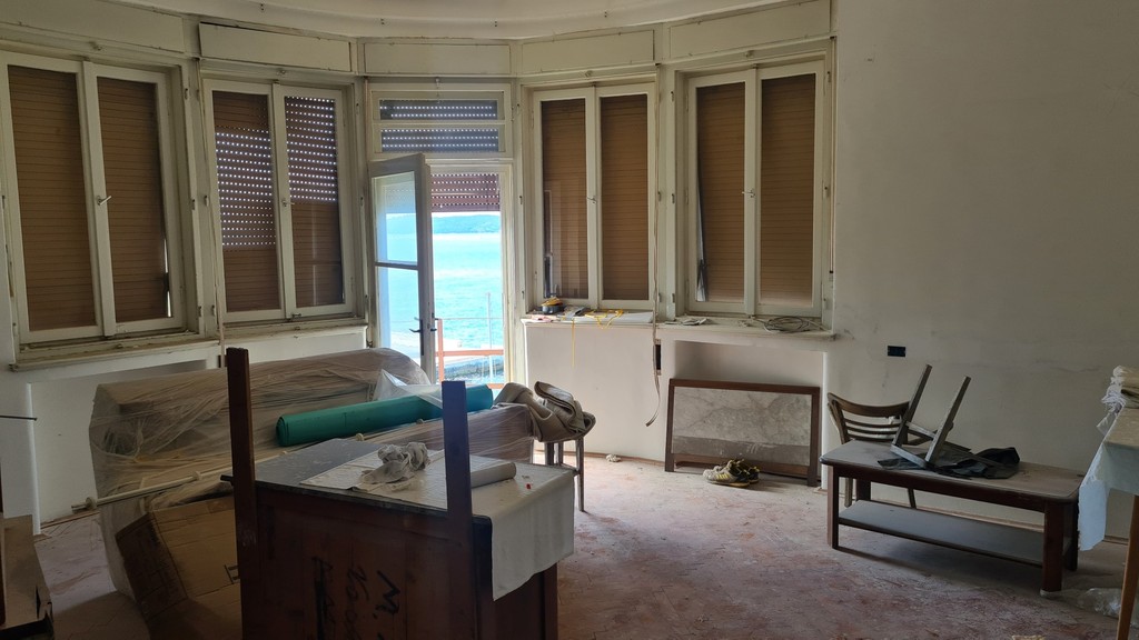 Salon z wykuszowymi oknami i drzwiami na balkon