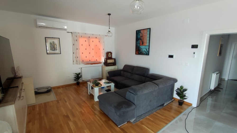 Na sprzedaż nowoczesny salon w domu w Vodicach w Chorwacji, z eleganckimi meblami i drewnianymi podłogami.