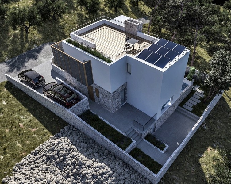 Widok z drona na nowo wybudowaną willę z tarasem na dachu i terenem zewnętrznym na sprzedaż w Krk w Chorwacji, otoczoną drzewami oliwnymi