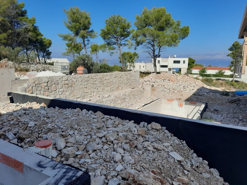 Prace budowlane przy nowoczesnej willi na sprzedaż na wyspie Brač, Chorwacja, z widokiem na morze.