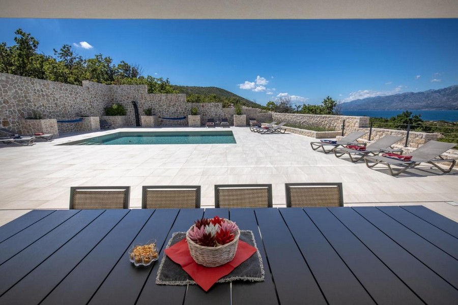 Taras z basenem i leżakami