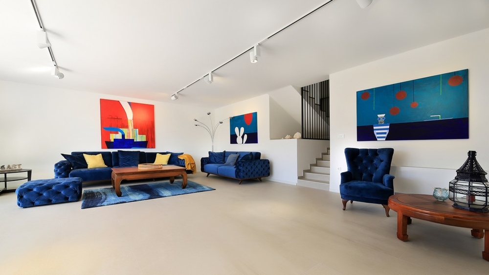 Widok z tarasu na dachu posesji z basenem i częścią wypoczynkową oraz na okolicę z morzem.