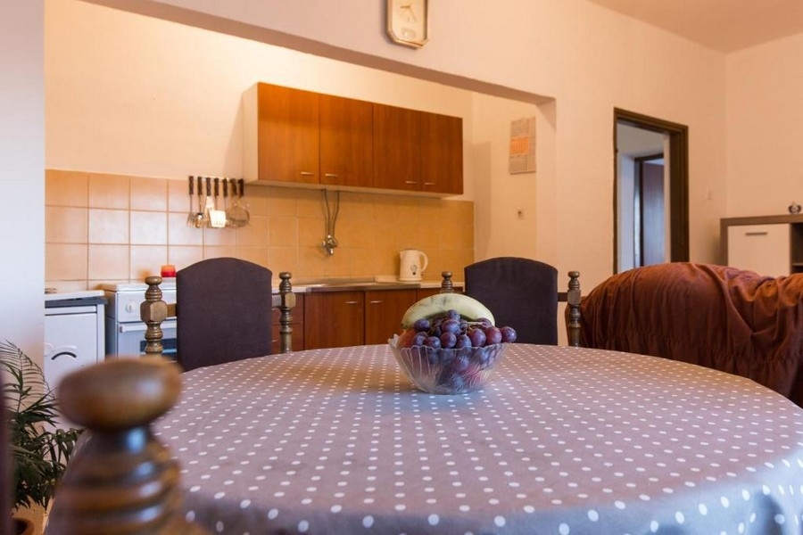 Jadalnia z okrągłym obrusem i otwartą kuchnią