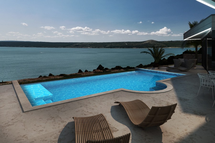 Basen (oświetlony) z panoramicznym widokiem na morze.