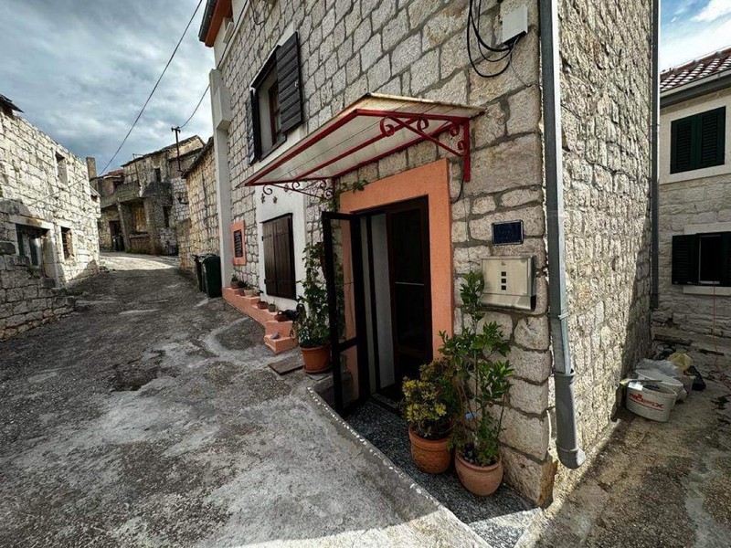 Wejście do kamiennego domu w alei