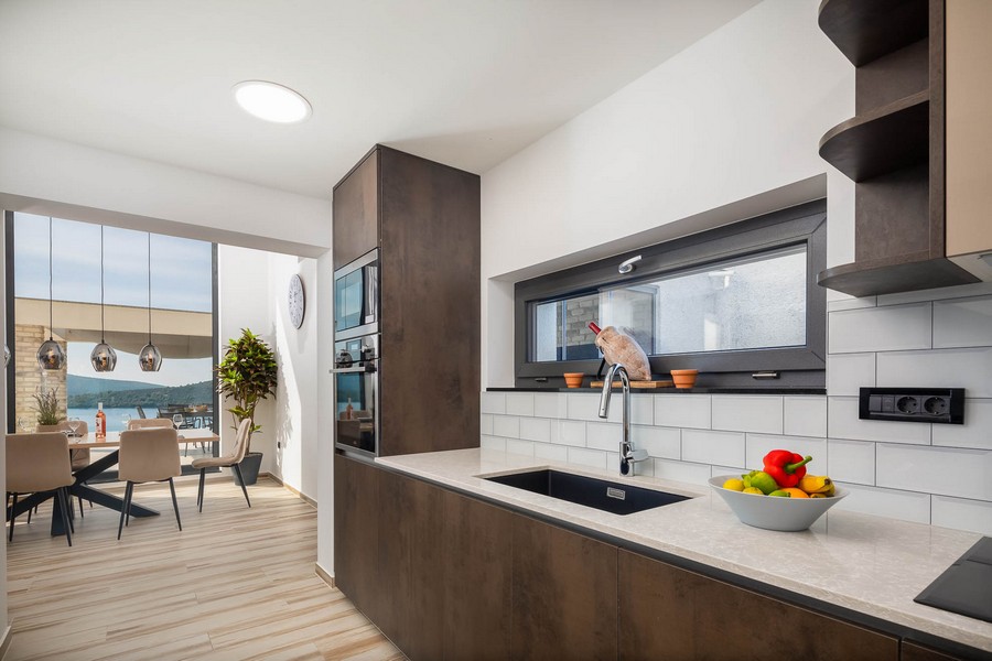 Nowoczesna kuchnia z jadalnią i widokiem na morze