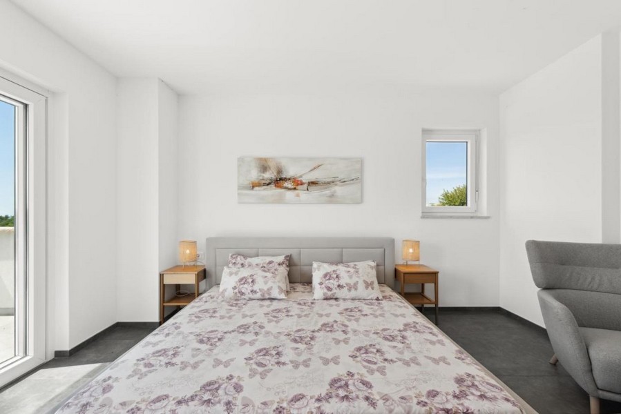 Sypialnia z łóżkiem małżeńskim i wyjściem na balkon