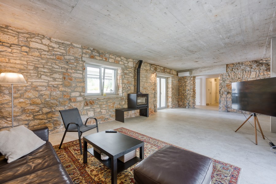 Pokój dzienny z kominkiem i ścianami z kamienia naturalnego