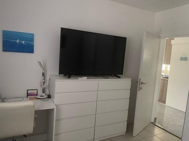 Sypialnia z komodą i dużym telewizorem