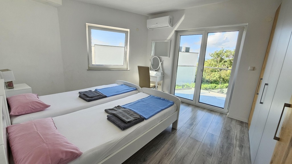 Sypialnia z dwoma łóżkami i dostępem do balkonu