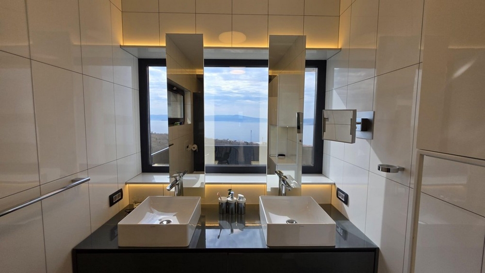 Łazienka z podwójną umywalką i widokiem na morze