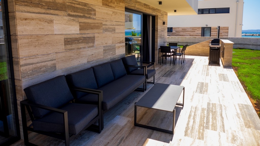 Zadaszony taras z salonem i miejscem do grillowania