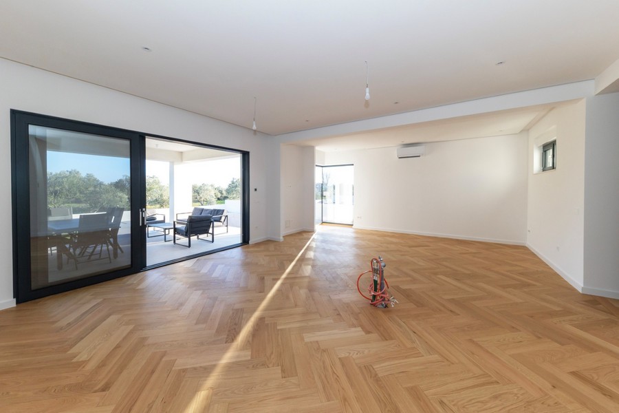 Otwarta część dzienna z dużymi oknami i wyjściem na taras