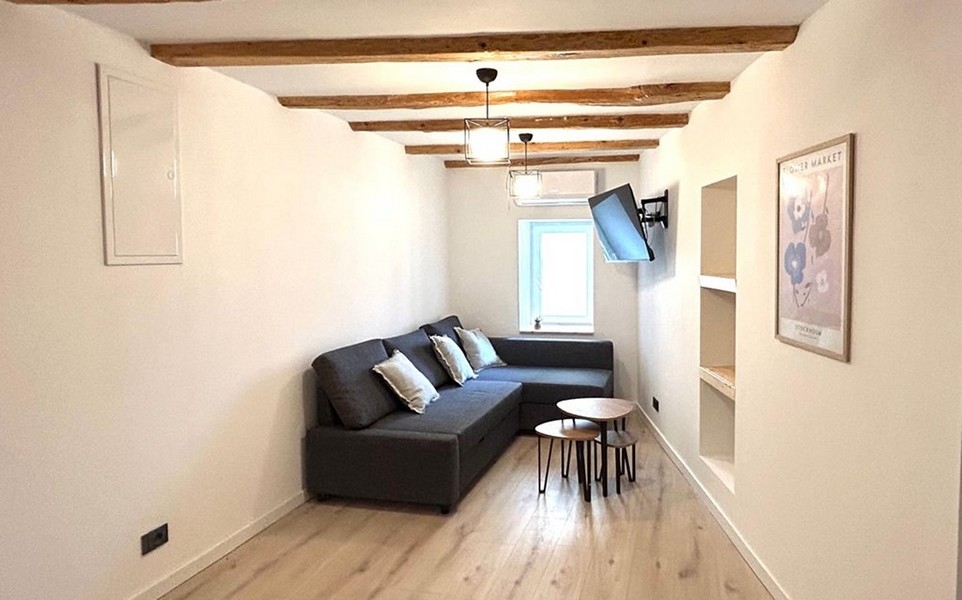 Część dzienna z sofą i belkami stropowymi