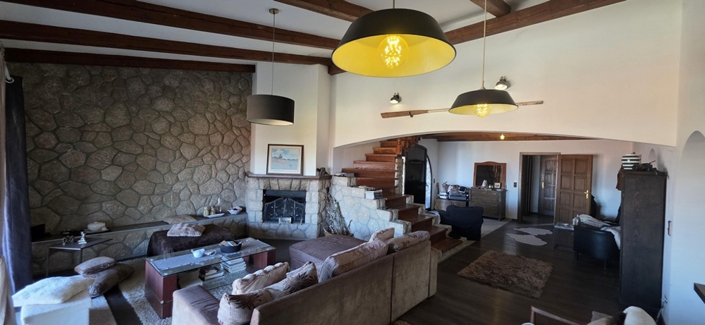 Galeria na piętrze z drewnianymi schodami i otwartą aranżacją wnętrz