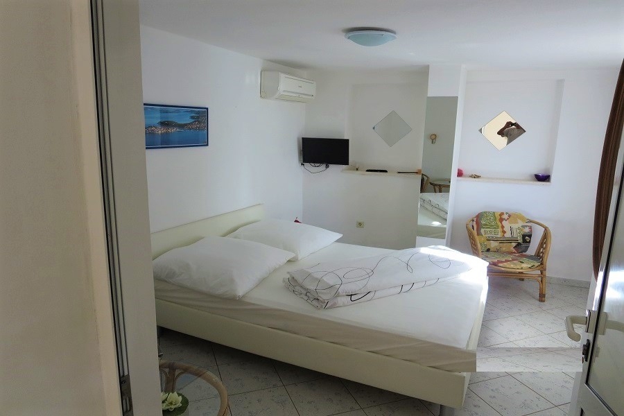 Sypialnia z podwójnym łóżkiem, klimatyzacją i jasnymi meblami