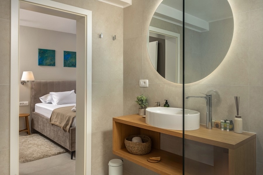 Łazienka z umywalką i okrągłym lustrem