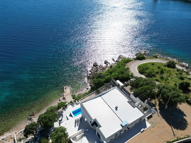 Krystalicznie czyste morze i kamienista plaża pod willą