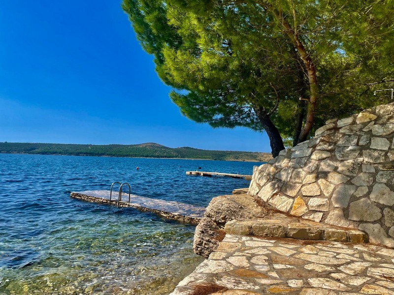 Molo na wodzie z naturalnym kamiennym murem w Chorwacji